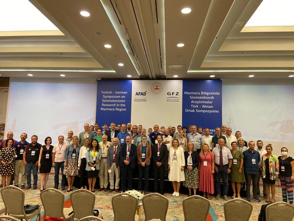 Guppenbild mit vielen Menschen in einem Konferenzsaal.