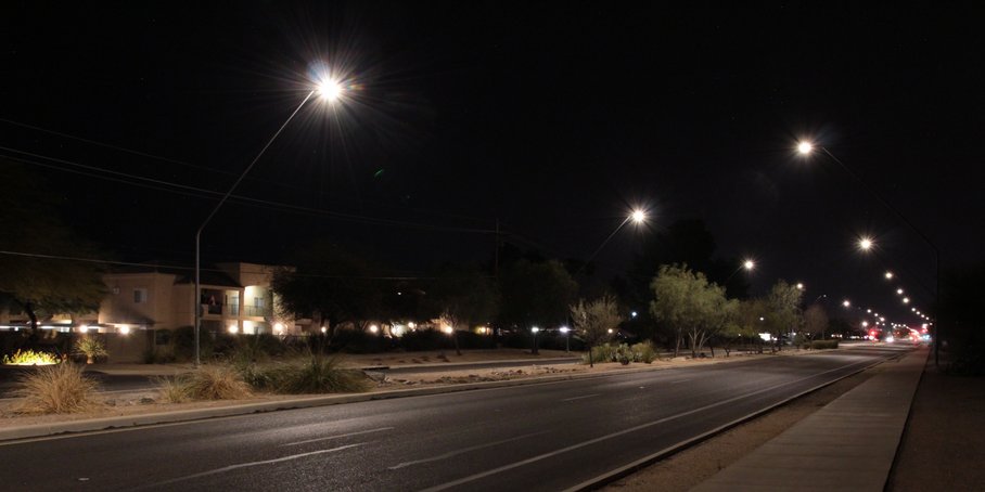 Street at night with dimmed street lights.