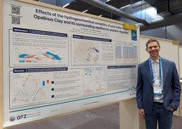 Tim Schöne in front of his scientific poster