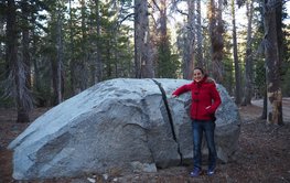P. Martinez Garzon in a forest next to a giant split rock