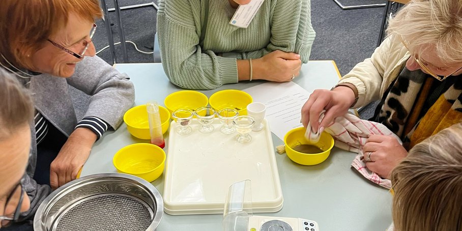 Workshop photo of five participants around a document.
