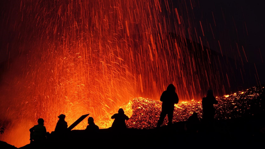 Volcano eruption, scientists in rain of fire from a safe distance
