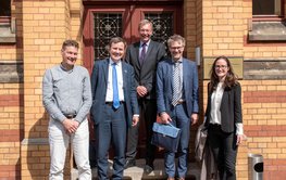Fünf Personen stehen vor dem Eingang der Historischen Bibliothek