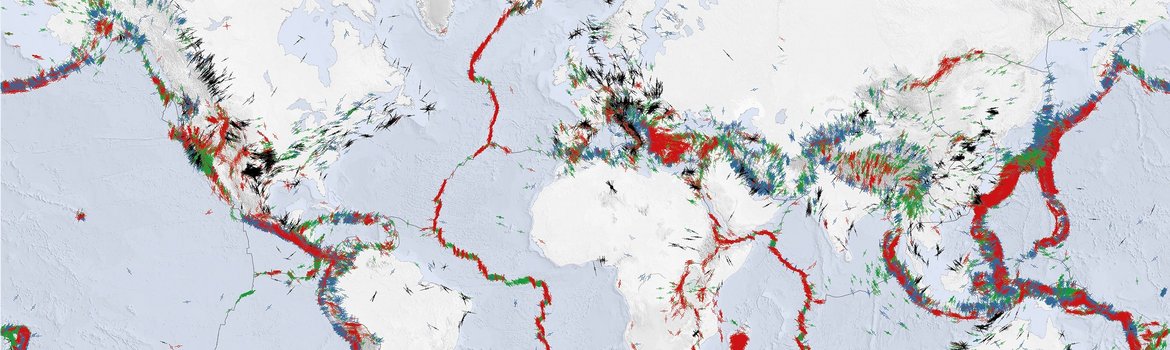 World map: Sea light blue, continents white. Short lines in bright colours indicate the direction of the greatest horizontal tension at many points, especially along plate boundaries, with many points in Central America and South-Eastern Europe/Turkey.