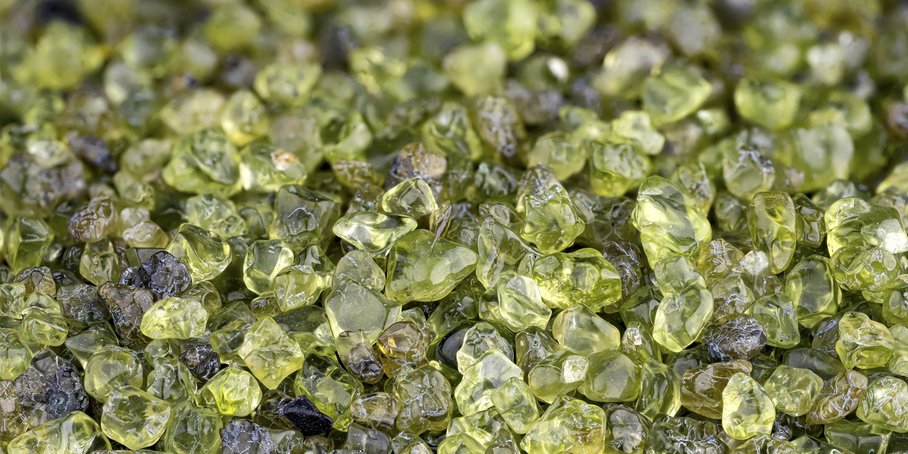 Close-up on a bed of green angular olivine crystals