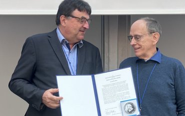 Richard Wirth mit einer weiteren Person bei der Urkundenübergabe