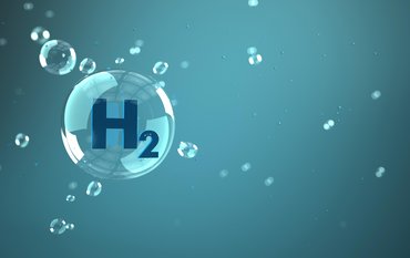 A graphic depicting one large and several small hydrogen bubbles against a blue-green background. The large bubble contains the letters H2.